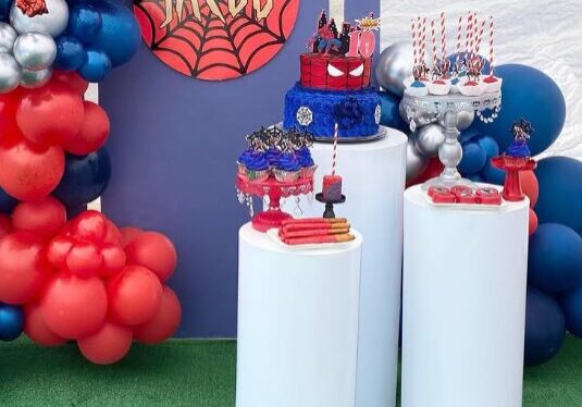Spider-Man themed birthday dessert table with balloon arch and custom cakes for a 10-year-old named Jacob