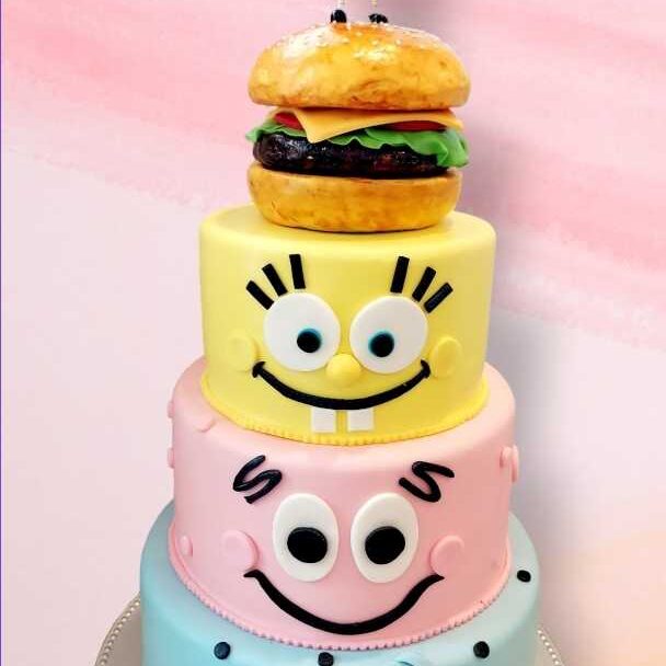SpongeBob SquarePants themed cake with character tiers including Patrick, Squidward, and a Krabby Patty topper